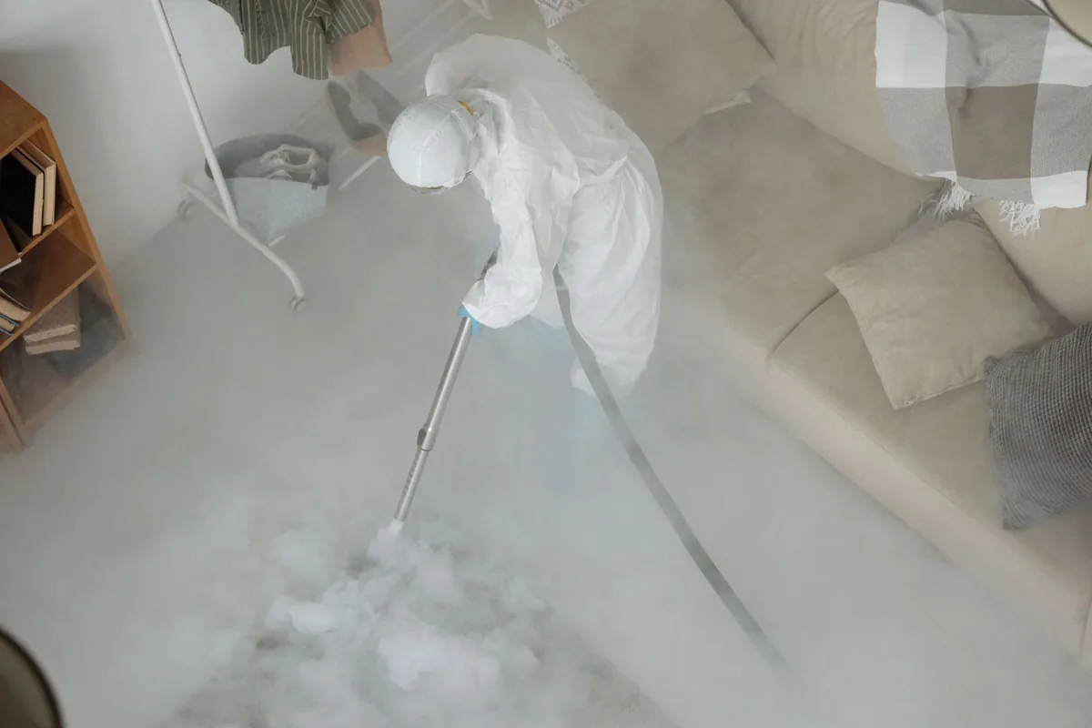 Biohazard cleanup technician in protective equipment, Bellevue, MI